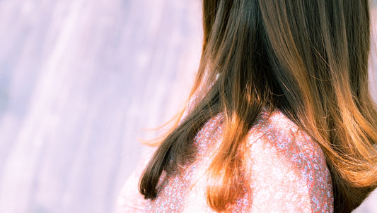 woman with brown hair in white shirt