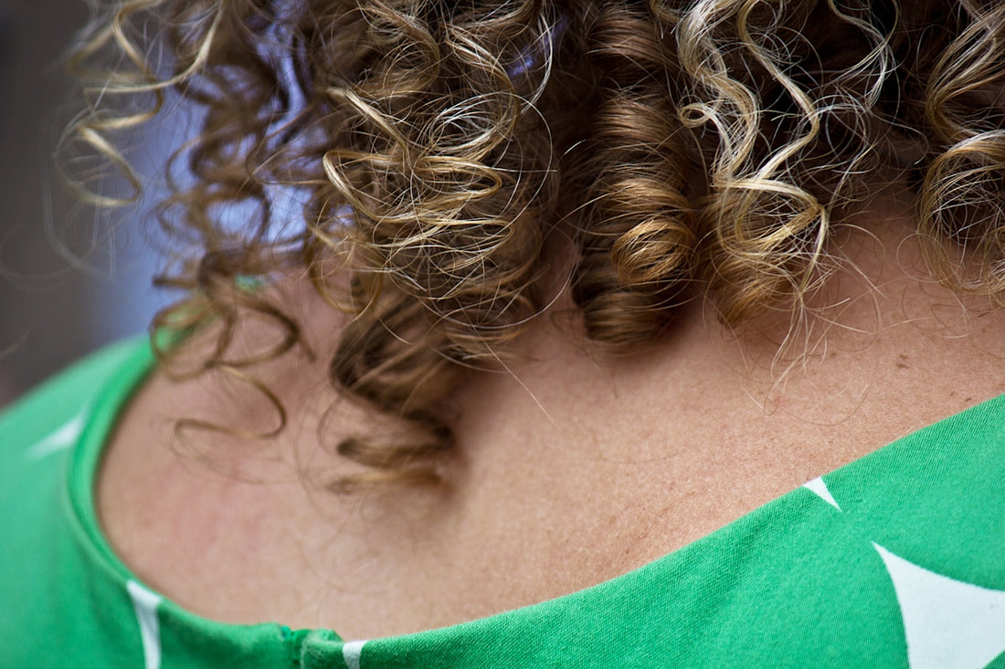 A close up of a woman with curly hair